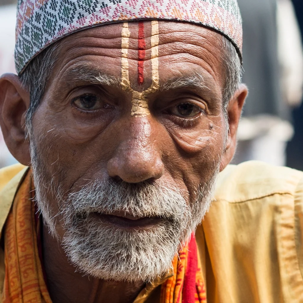Bahun priest performing Hindu ritual in Nepal with sacred thread and traditional attire