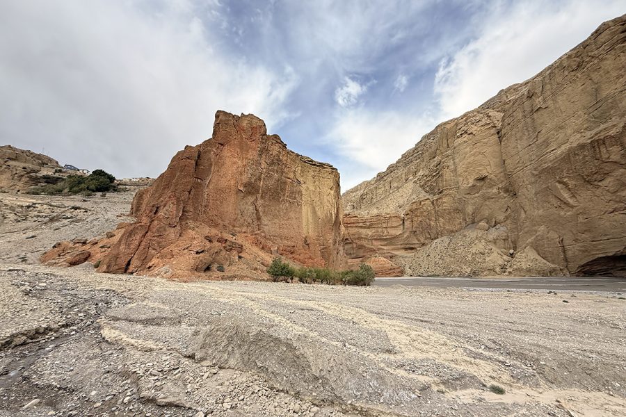 rugged-red-cliffs-of-upper-mustang-showing-dramatic-ochre-and-crimson-rock-formations-against-blue-sky